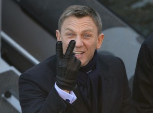 Actors Daniel Craig jokingly gestures to photographers as he films a scene for the new James Bond film, Spectre, in London, Tuesday, Dec. 16, 2014. (AP Photo/Alastair Grant)