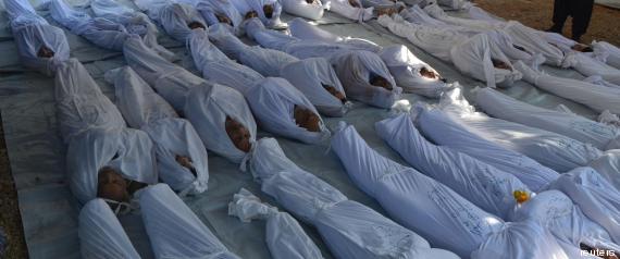 Syrian activists inspect the bodies of people they say were killed by nerve gas in the Ghouta region, in the Duma neighbourhood of Damascus